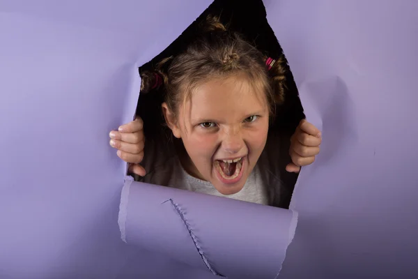 Silly Girl with crazy hair tearing through a purple backdrop