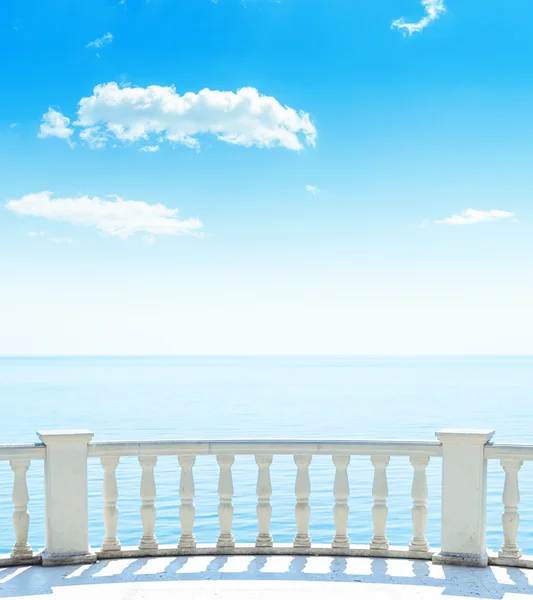 Balcony near sea and blue sky with clouds