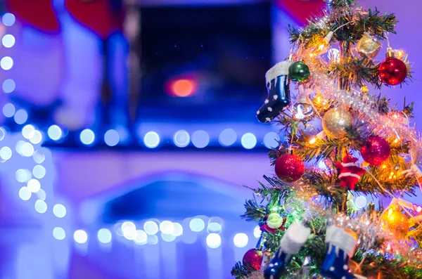 Xmas tree with Christmas present ornaments over bokeh holiday li