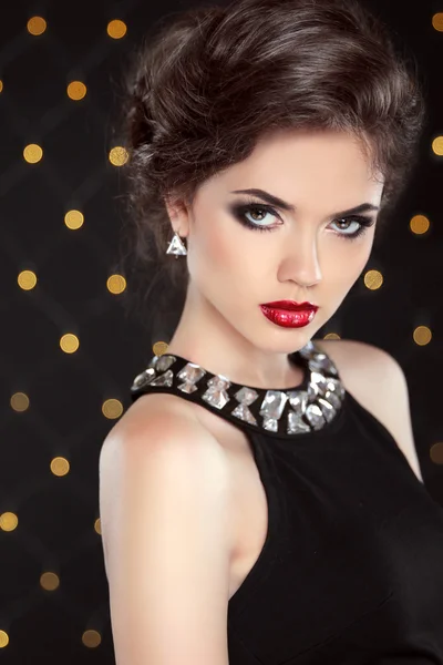 Beautiful model brunette with red lips and hairstyle. Fashion gl