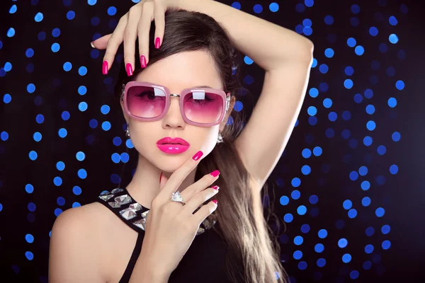 Beautiful  Girl Model in fashion sunglasses with pink lips, mani