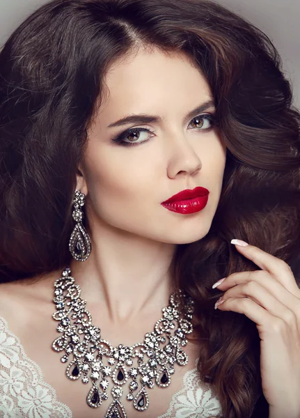 Portrait of beautiful brunette woman with red lips, long healthy