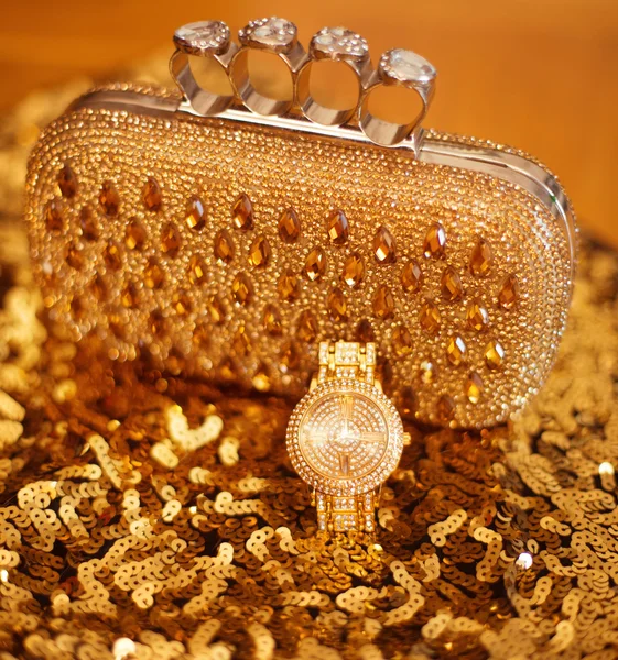 Fashion golden womens accessories. Luxury wristwatch and purse,