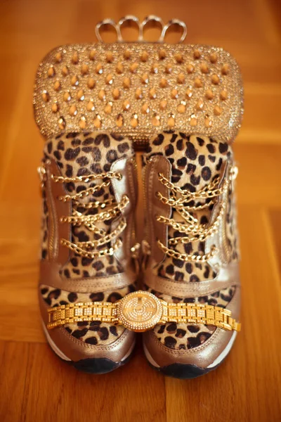 Women\'s accessories. Luxury golden wristwatch and purse, leopard