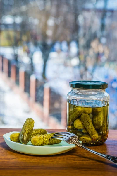 Pickled cucumbers in glass jar.