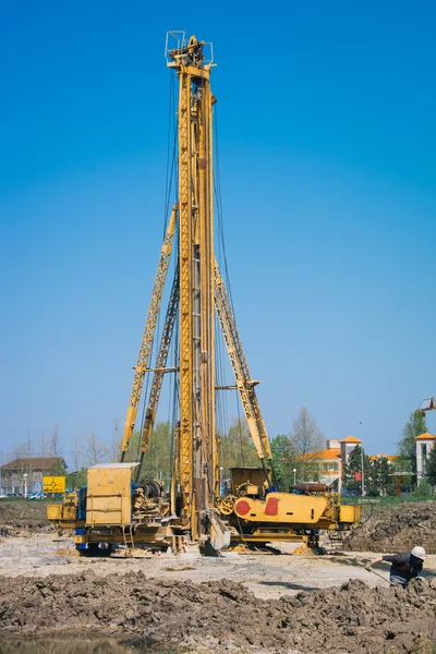 Construction site with workers and hydraulic drilling machines