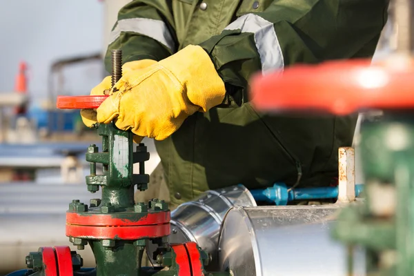 Oil worker turning valve