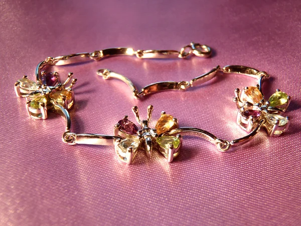 Silver bracelet with multi-colored cubic zirconias, macro. Jewelry macro.