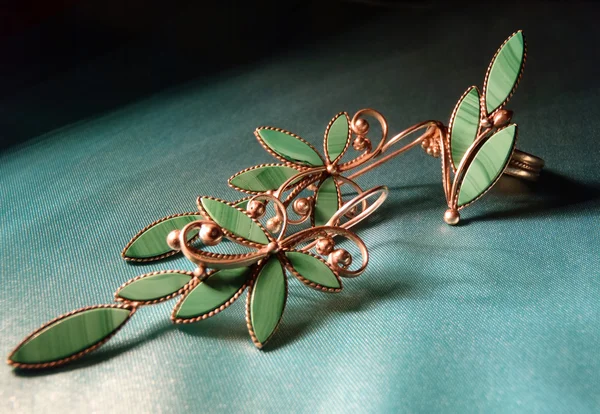 Set of silver jewelry: earrings and a ring with malachite.