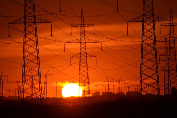 Electric power transmission lines at sunset.