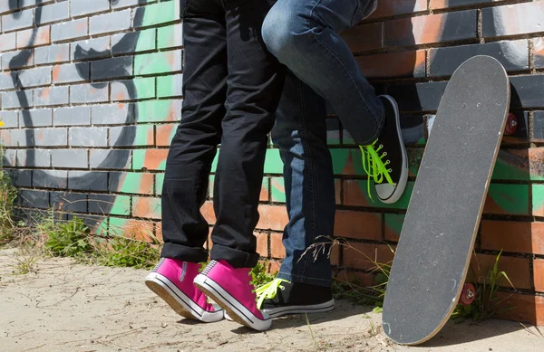 Couple of guys with his skateboard