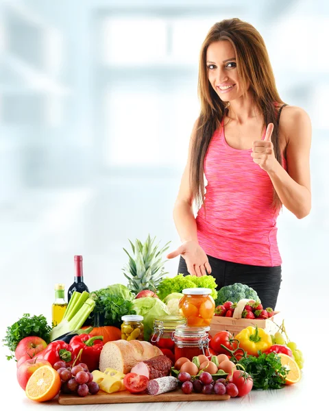 Young woman with assorted organic food products