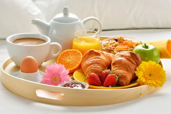 Breakfast tray in bed in hotel room