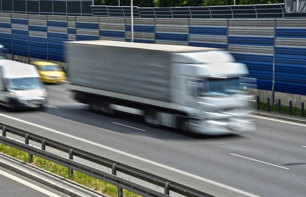 Large goods vehicle moving at full speed on six lane highway