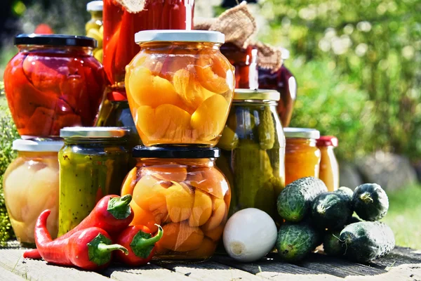 Jars of pickled vegetables and fruits in the garden