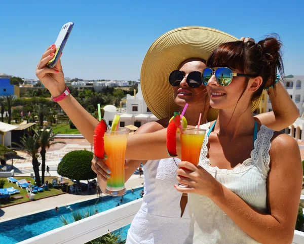 Two young women taking picture of themselves on vacation