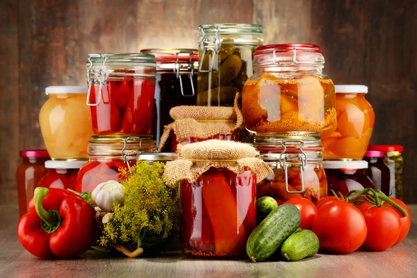 Jars with pickled vegetables and fruity compotes