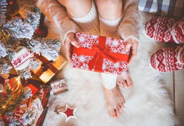 Young pretty woman holds gift box in her hands