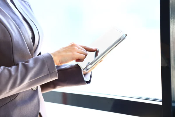 Businesswoman\'s hand presses on screen digital tablet