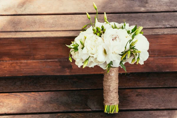 Rustic wedding bouquet on brown wooden backgraund on ceremony pl