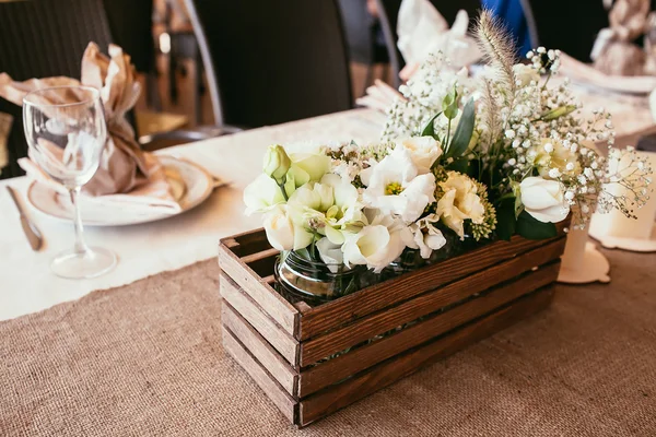 Rustic wedding decorations. wooden box with bouquet of flowers o