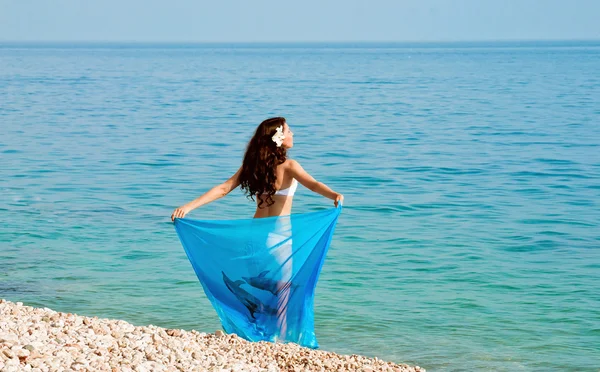 Girl on the beach with a blue handkerchief