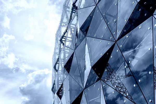 Reflection of buildings in the glass triangles on the facade