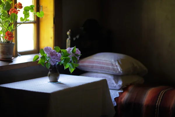 Vase of flowers in the bedroom of an old house