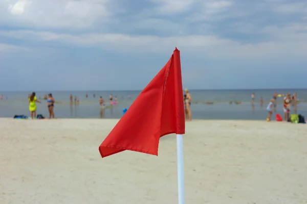 Red flag on a sandy beach