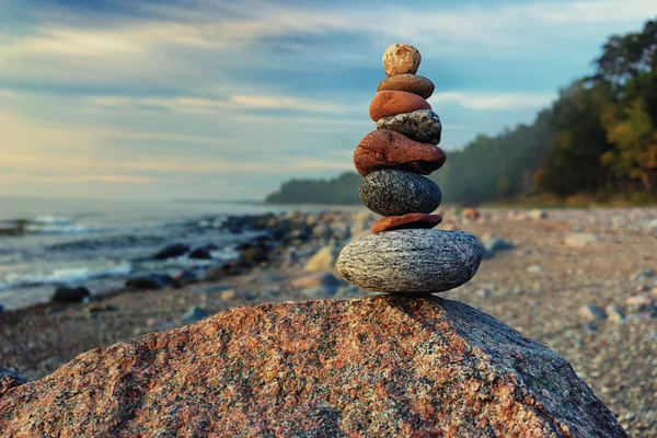 Sustainable cairn at sea in pastel colors