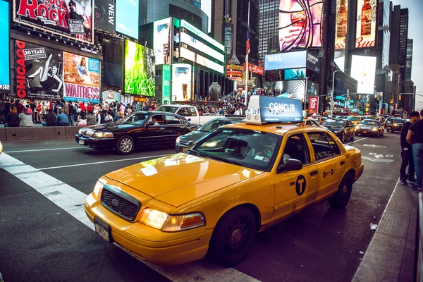 NEW YORK CITY - MAY 12: Yellow cab on Times Square traffic and animated LED signs, is a symbol of New York City and the United States, May 12, 2016 in Manhattan, New York City. USA.