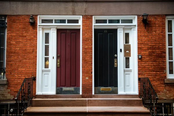 View of Front Doors of Two Neighbouring Red Brick English Town Houses on a Residential Estate. New York City Manhattan buildings