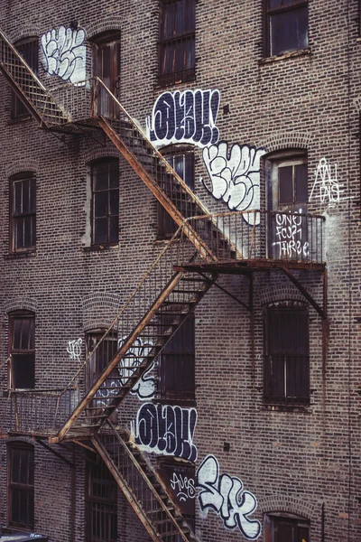 Fire escape stairs on an old building exterior in New York, Manhattan