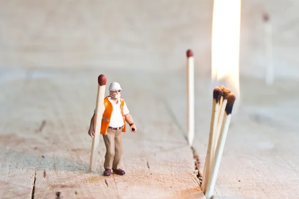 Miniature man with matchsticks