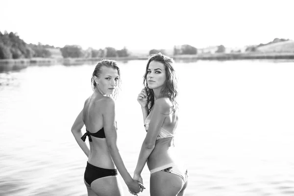 Black and white two women on summer river