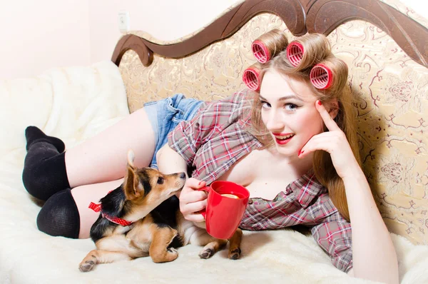 Girl with dog on bed