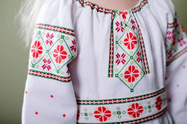 Girl in handmade embroidered clothes with handbag