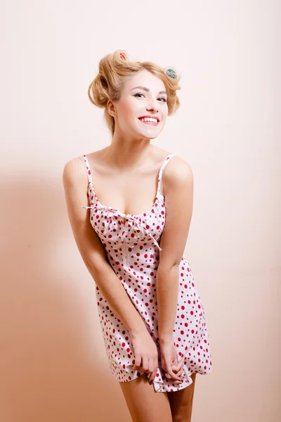 Smiling woman with hair curlers on