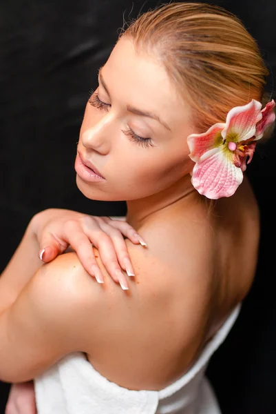 Fashion portrait of young pretty blond girl with pink lily