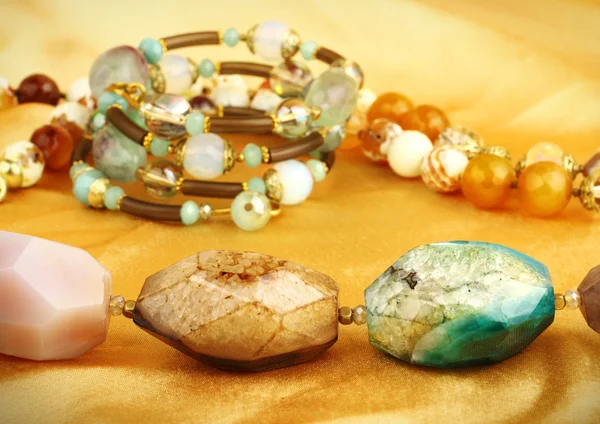 Jewelry gem stones on golden background