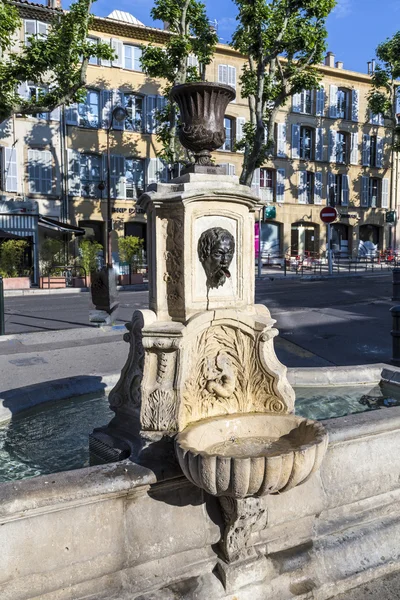 Old water fountain with greek roman face at faucet