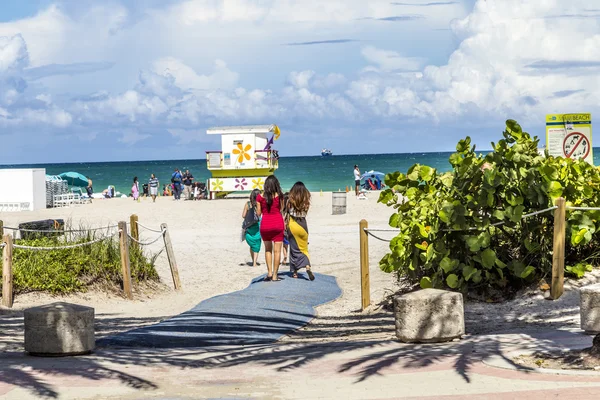 People enjoy the hot summer day at south beach in Miami