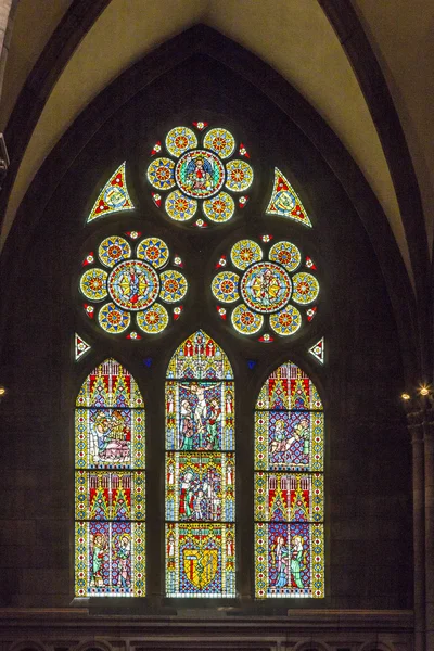 Beautiful windows of the minster show religious scenes from the