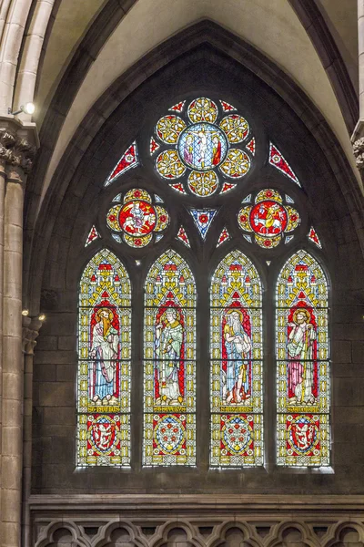 Beautiful windows of the minster show religious scenes from the