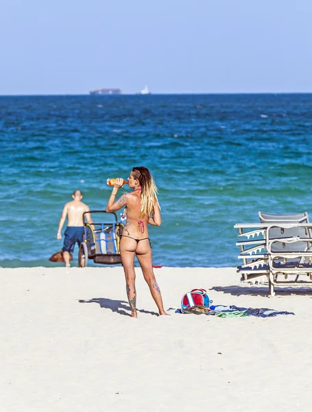 People enjoy the beautiful beach at South Beach, Miami