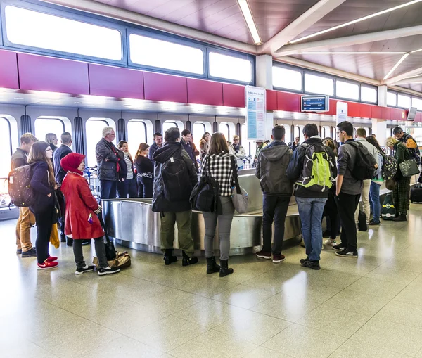 People wait at baggage belt  in  Tegel airport