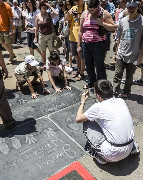 People admire the hand and Footprints of Harry Potter