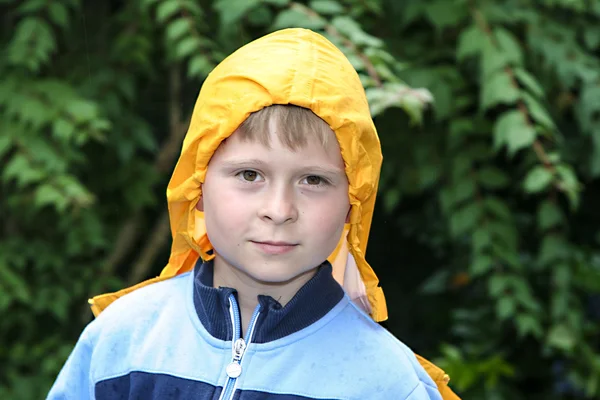 Cute boy with yellow rain jacket