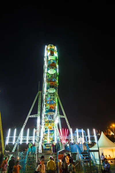 People enjoy the big wheel in the amusement park in Delhi