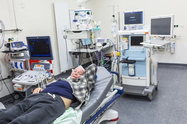 Sick senior lying in a hospital bed